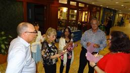 A group of people standing in a room

Description automatically generated